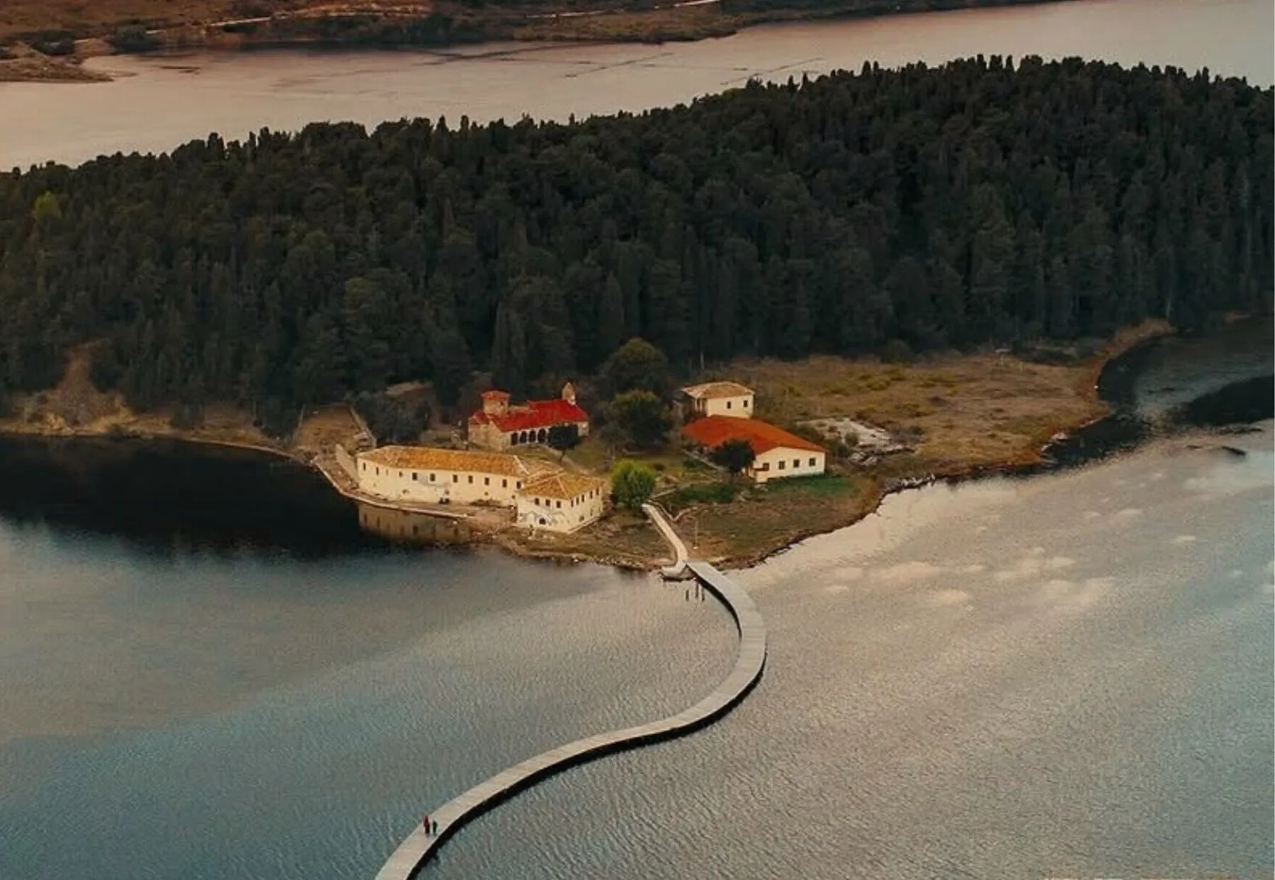 Aerial view of Zvërnec Monastery and the wooden walkway across Narta Lagoon, Vlorë